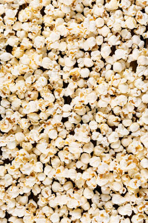 Top view of popcorn texture on dark wooden background verticalの写真素材