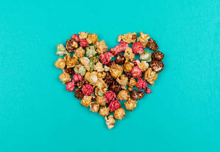 Top view of popcorn heart on blue background horizontalの写真素材