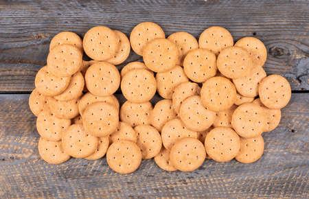 Top view of crackers on dark wooden background horizontalの写真素材