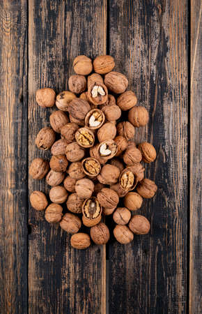 Top view walnuts ion wooden background vertical