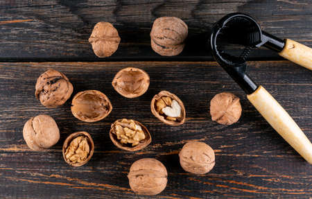 Top view walnuts and nutcracker on wooden background horizontalの写真素材