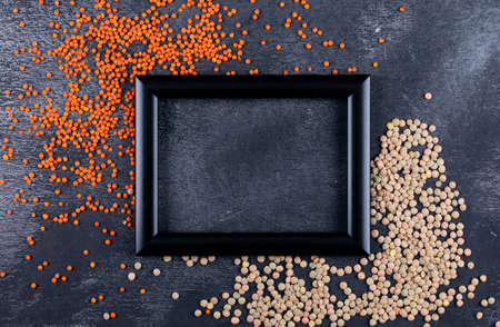 Top view green and red lentils with black frame for text to photo on black stone background. horizontalの写真素材