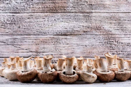 Flipped mushrooms on a wooden background. side view. free space for your textの写真素材