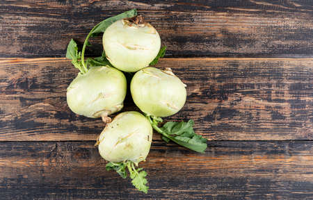 Fresh white radishes on a wooden textured background. top view. copy space for text