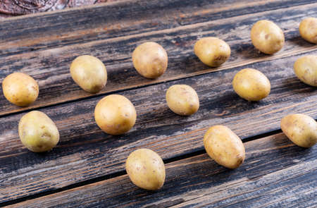High angle view potatoes on dark wooden background. horizontalの写真素材