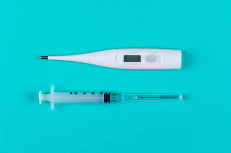 Thermometer with needle top view on a cyan blue background