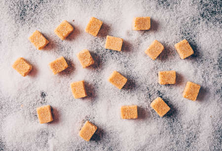 Brown sugar on a sugar powder background. top view.