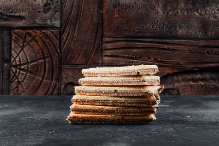 Waffles in a plate top view on a black textured and wooden backgroundの写真素材