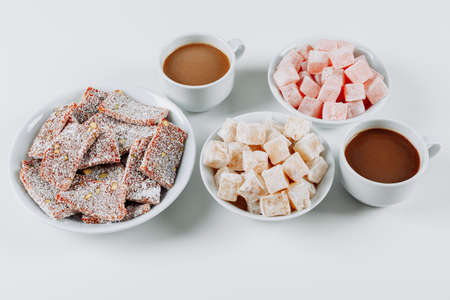 High angle view turkish delight lokums in bowls, with coffee on white background. horizontalの写真素材