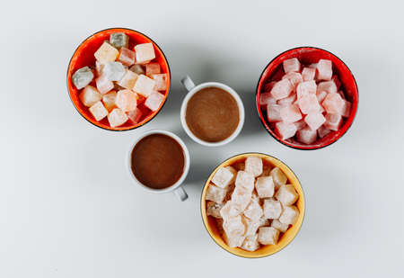 Set of coffee and turkish delight lokums in a bowls on a white background. top view.