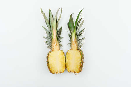 Pineapple cut into halves top view on a white backgroundの写真素材