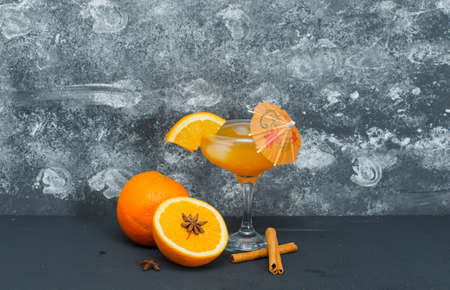 Set of juice in a glass and oranges on a gray textured background. side view.の写真素材