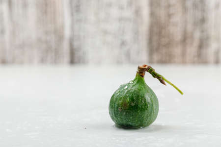 Chilly fig side view on white and grungy wooden backgroundの写真素材