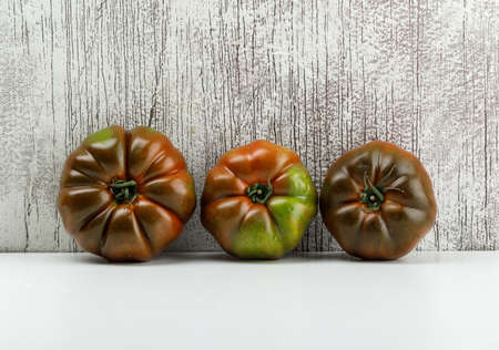 Kumato tomatoes on white and grungy background. side view.の写真素材