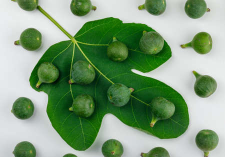 Ripe figs with leaf on white background, flat lay.の写真素材