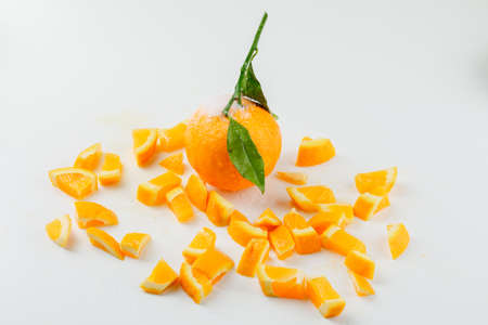 Orange and slices with branch high angle view on a white backgroundの写真素材