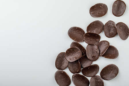 Dark chocolate candies on white background, flat lay.の写真素材