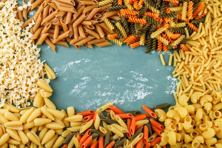 Assorted pasta set on a plaster background. flat lay. 
