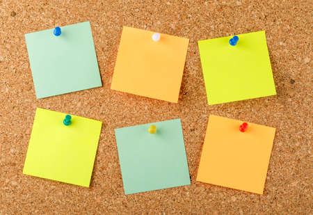 Pinned sticky notes on a light background. flat lay.