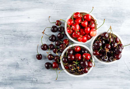 Cherries in bowls top view on a grunge backgroundの写真素材