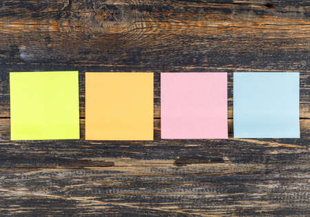 Colorful sticky notes on a wooden background. flat lay.