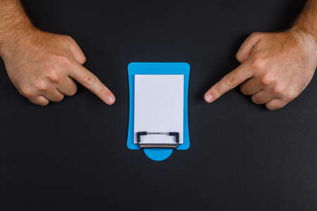 Valuable content concept with mini note papers on black desk backgroud flat lay. hands show it . free space for your text horizontal imageの写真素材