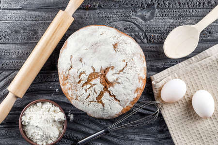 Bakery product with rolling pin, flour, eggs top view on a gray wooden background の写真素材