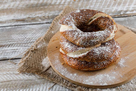 High angle view turkish bagel on cutting board and wooden background. horizontal 