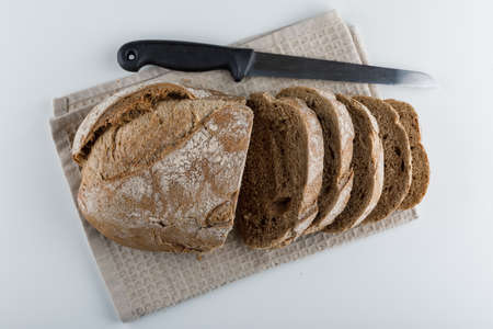 Top view sliced bread with knife on white background. horizontalの写真素材