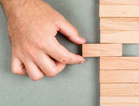 Different thinking and different idea concept with wooden blocks on navy green background top view....
