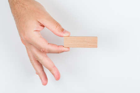 Choice concept on white background top view. man holding wooden label. horizontal imageの写真素材