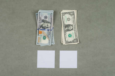Business and financial concept with dollars, sticky notes, magnifying glass on grey background flat lay.の写真素材