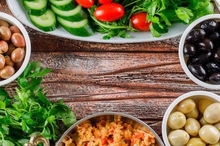 High angle view delicious meal in pot with salad, pickles in bowls on wooden background. horizontal space for textの写真素材