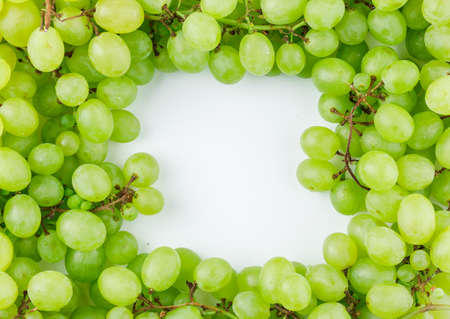Green grapes flat lay on a white background