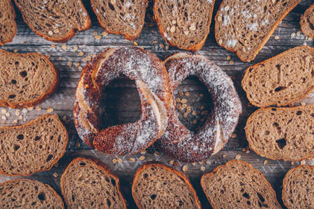 Top view slices of bread with turkish bagel on wooden background. horizontal の写真素材