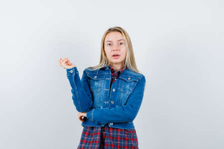 blonde lady posing while standing in shirt, jacket and looking pretty. front view.の写真素材