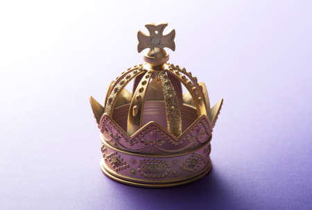 Gold Crown on a Purple Backgroundの写真素材