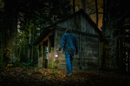 Exploring the mountain woods with a little lampの写真素材