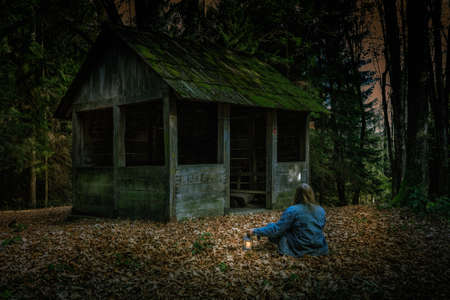 Exploring the mountain woods with a little lampの写真素材