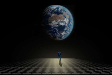 Lonely man nostalgically watching Earth from outside space and timeの写真素材