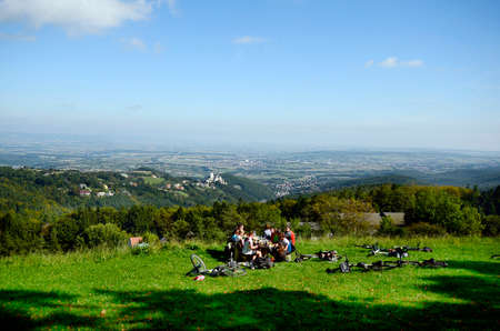 Forchtenstein, Austria, unidentified cyclists rest in Rosalia mountains with view to village and castle Forchtenstein in Burgenlandのeditorial素材