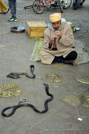 Marrakesh, Morocco - unidentified snake charmer and snakes on place Djemaa el-Fna - a Unesco world heritage siteのeditorial素材