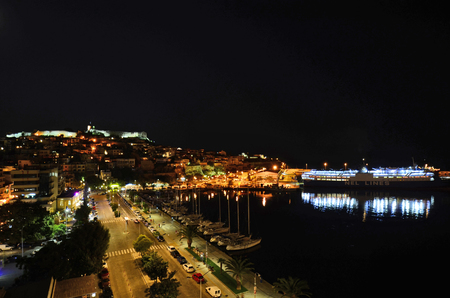 Kavala, Greece - Illuminated view of the city in Eastmacedonia with castle, homes and car ferry in the harborのeditorial素材
