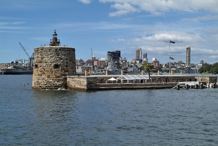 Australia, Sydney, building Fort Denison, a former prison,  now restaurant, in background warships in Wooloomooloo wharfのeditorial素材