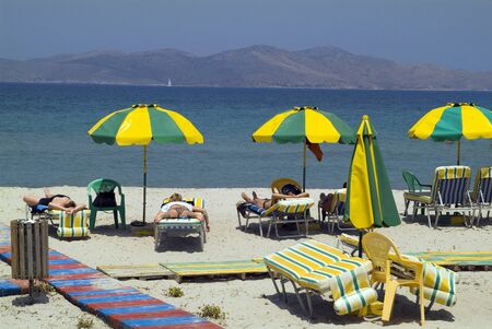Greece, unidentified tourists relaxing on the beach of Tigkaki on Cos islandのeditorial素材