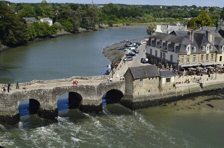 Auray, France - June 8th, 2011: Unidentified people in medieval village with old stone bridgeのeditorial素材
