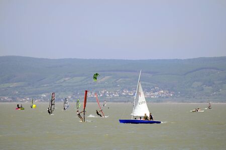 Podersdorf, Austria - April 29th 2012: Unidentified people in saling boats and wind surfer on Neusiedler lake in Burgenlandのeditorial素材