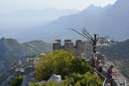 Kyrenia, Cyprus - October 17th 2015: Unidentified tourists by sightseeing of impressive medieval fortress of St. Hilarionのeditorial素材