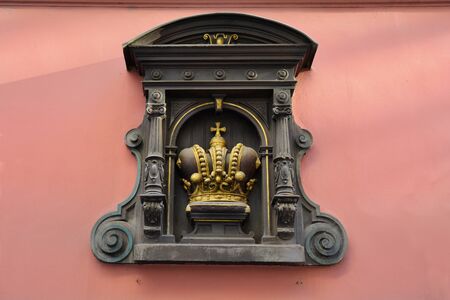 Prague, Czech Republic - sculpture with crown on facade of a building