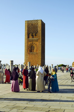 Rabat, Morocco - November 18th 2014: Unidentified tourists and woman in traditional Kaftan sightseeing on the place of Hassan tower - a landmark of the cityのeditorial素材
